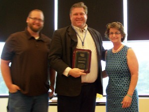 Chuck Speelman, center, receives the 2013 Marion Area CVB Community Ambassador award from Van Creasap, Marion Area CVB board chair, and Diane Watson, Marion Area CVB Executive Director.