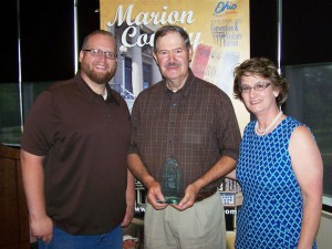 Dennis Mattix accepts the 2013 Marion Area CVB Customer Service Star Award for himself and his wife Donna from Van Creasap, Marion Area CVB board chair, and Dane Watson, Marion Area CVB Executive Director.