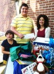 Carrie Guyton (right) of the Marion YMCA presents James Lemley and his younger sister Kaitlyn with a family membership as part of the first place prize for the Marion’s Amazing Treasures summer playing card promotion.