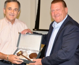 Rex Parrott, former Board Chairman, (left) receiving a gift of a gavel from current Chairman Don Plotts (right).